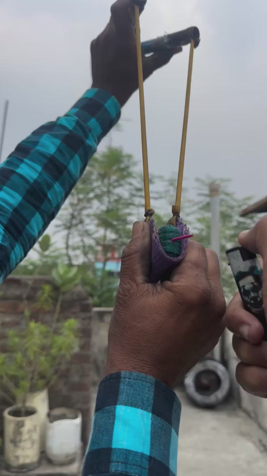 Two Friends Set Off a Firecracker Using a Slingshot