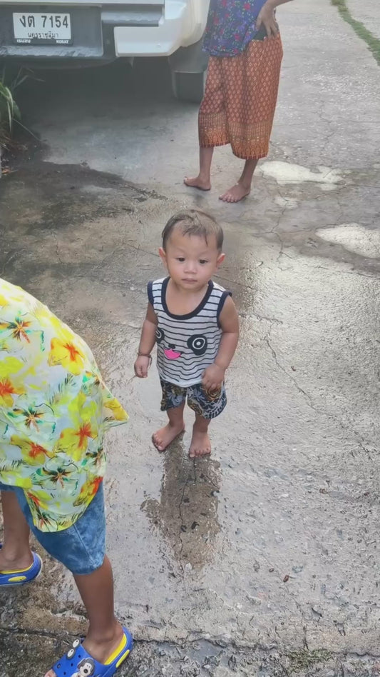 Child Looks Unfazed While Being Shot at With Water Pistol
