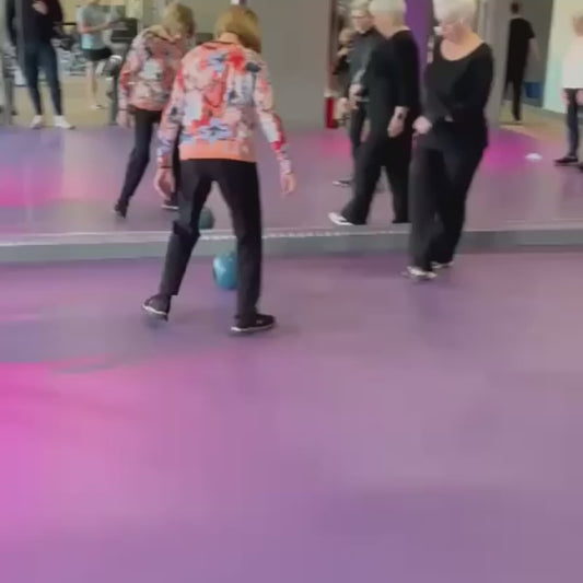 Elderly Women Play Football During Fitness Class
