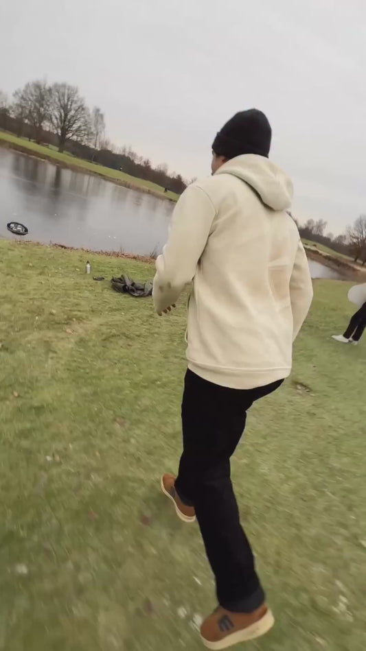 Man Slides Across Frozen Lake