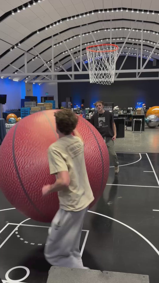Guys Play Basketball with Extremely Large Ball and Hoop