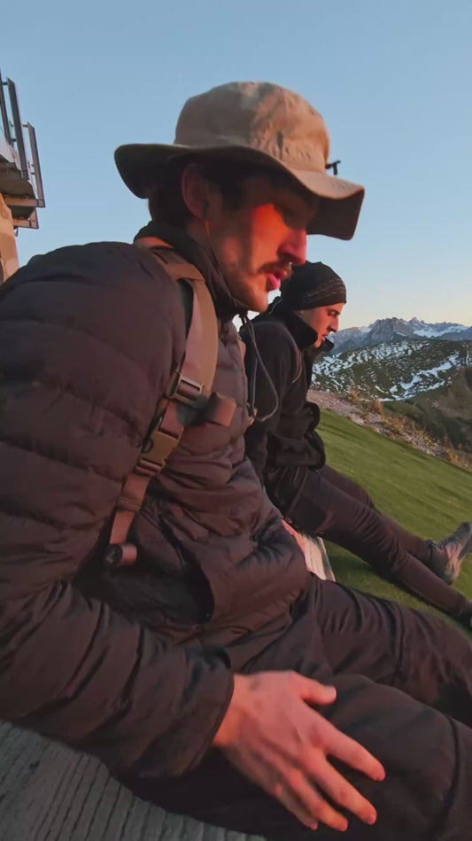Guys Slide Down Hill With Stunning View