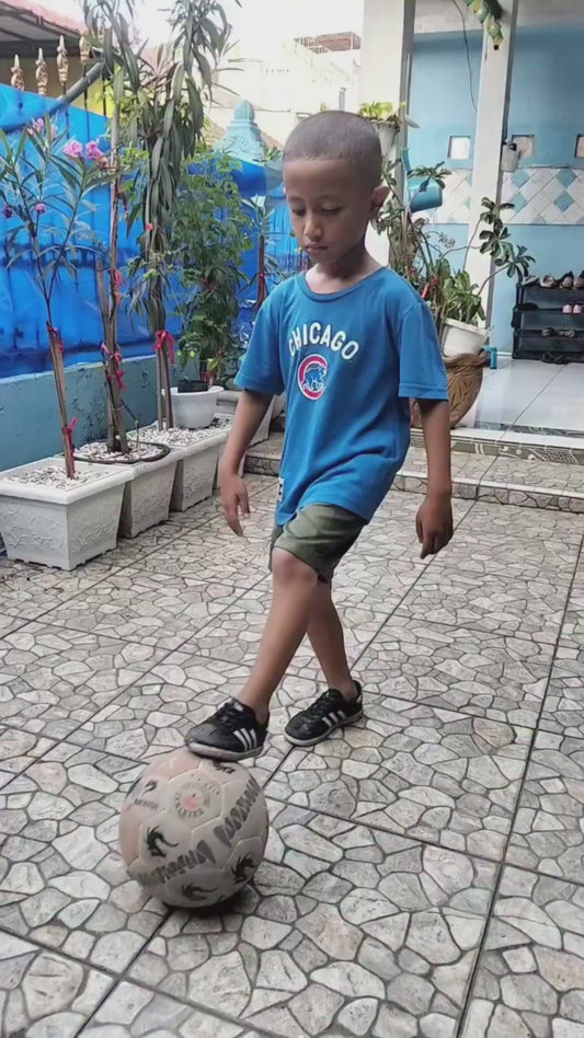 Kid Slips Over While Doing Kick Ups