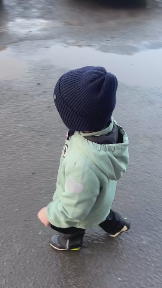 Funny Child Loves Playing in Muddy Puddles