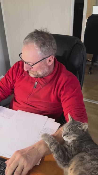 Cat Refuses to Leave Owner's Side While He's Working