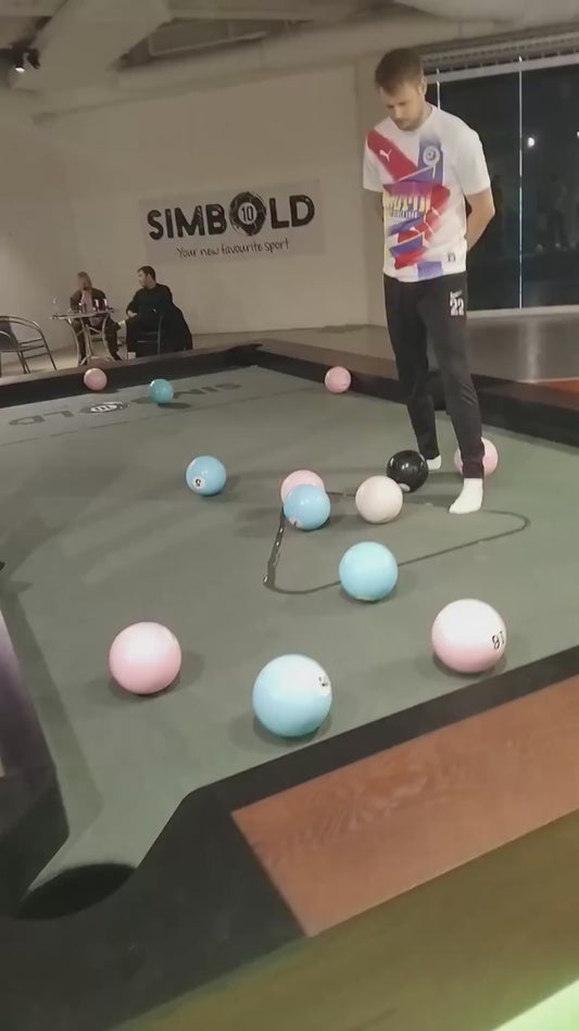 Two Friends Play “Simbold” - a Cross Between Football and Pool