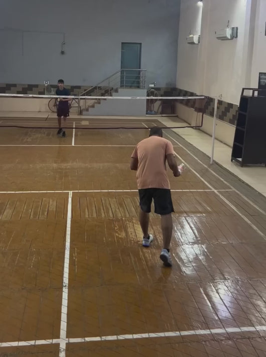 Guy Plays Badminton Using an Empty Bottle
