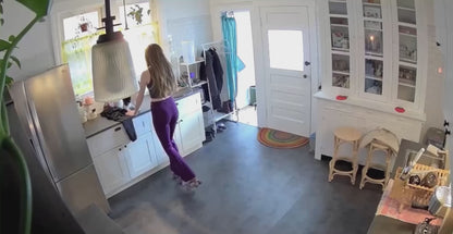 Woman on Roller Skates Dances with Her Cat in the Kitchen
