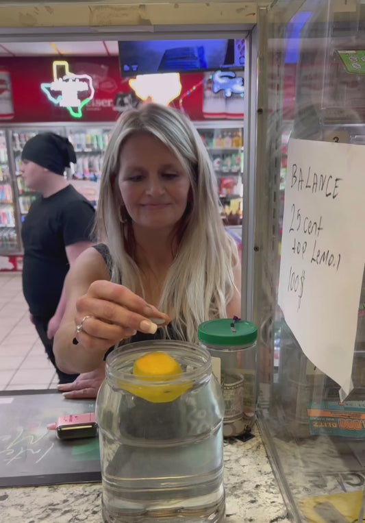 Customers Attempt to Balance Coin on Lemon