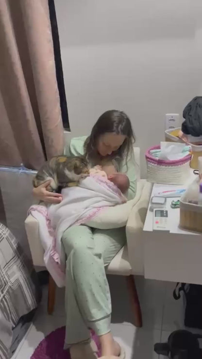 Cat Tenderly Watches Over Newborn During Breastfeeding
