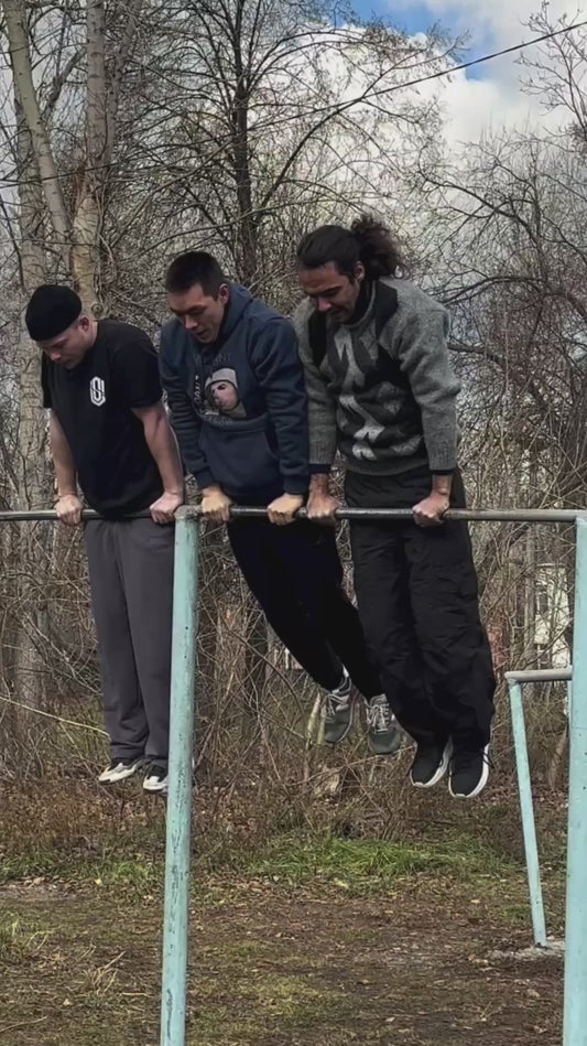 Friends Pull Off Insane "Helicopter" on Horizontal Bar