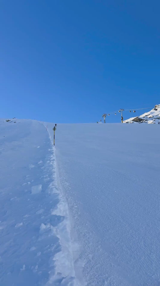 Guy Rockets Down the Slope on a Snow Bike