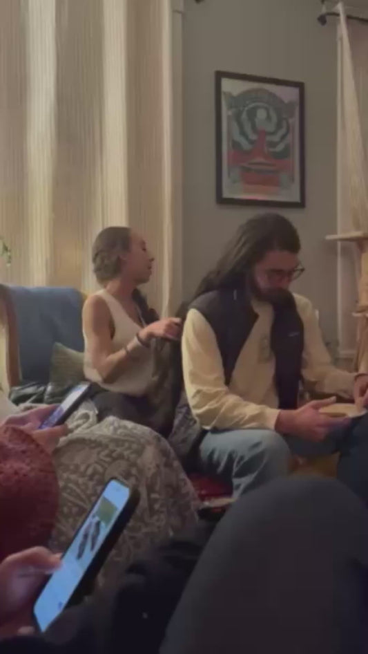 Bald Man Watches Long-Haired Friend Enviously