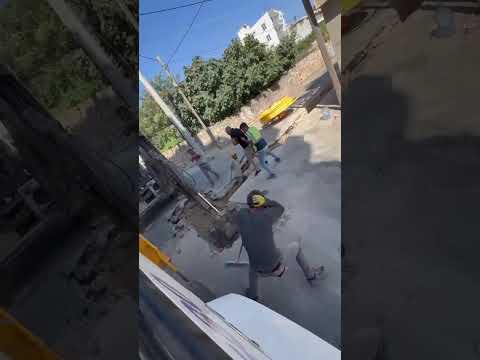 Construction Worker Pops Plastic Water Bottle in the Direction of His Coworker